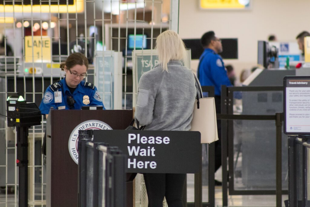 TSA agent checking a traveler's ID at an airport