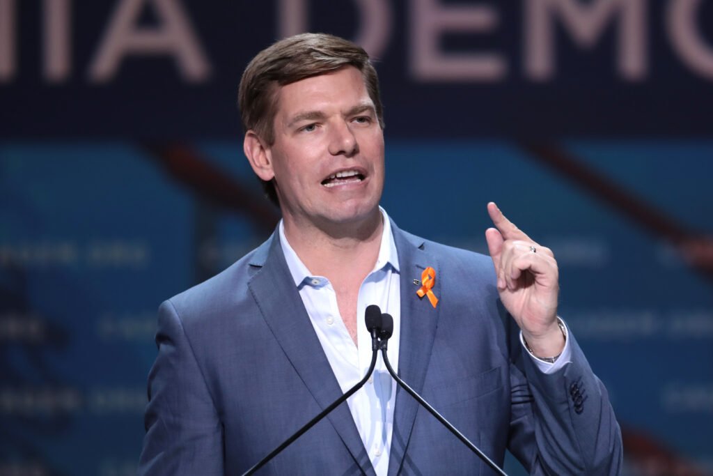 Eric Swalwell speaking from the podium at an event