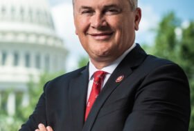 Rep James Comer smiling with his arms folded